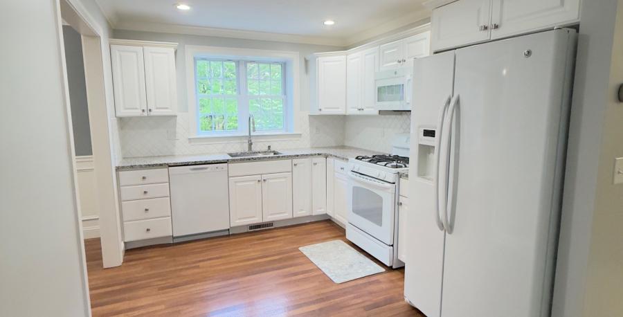 kitchen with white appliances and vinyl wood floor