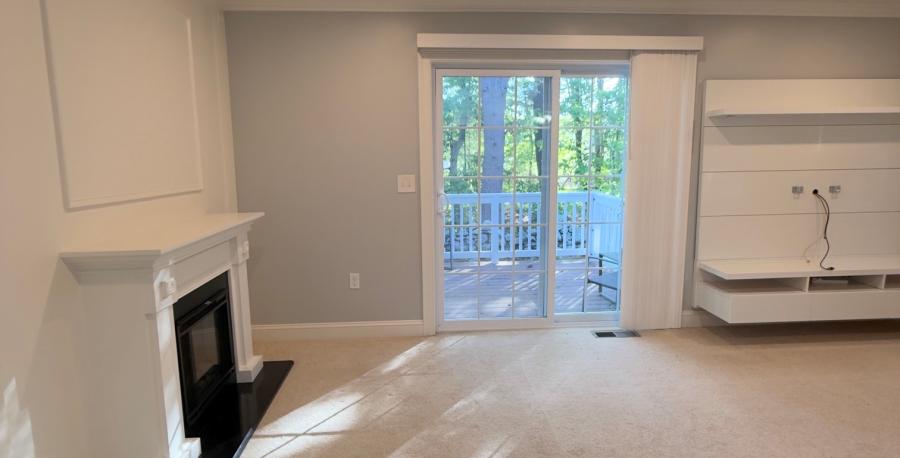 living room with fireplace and sliding doors to deck